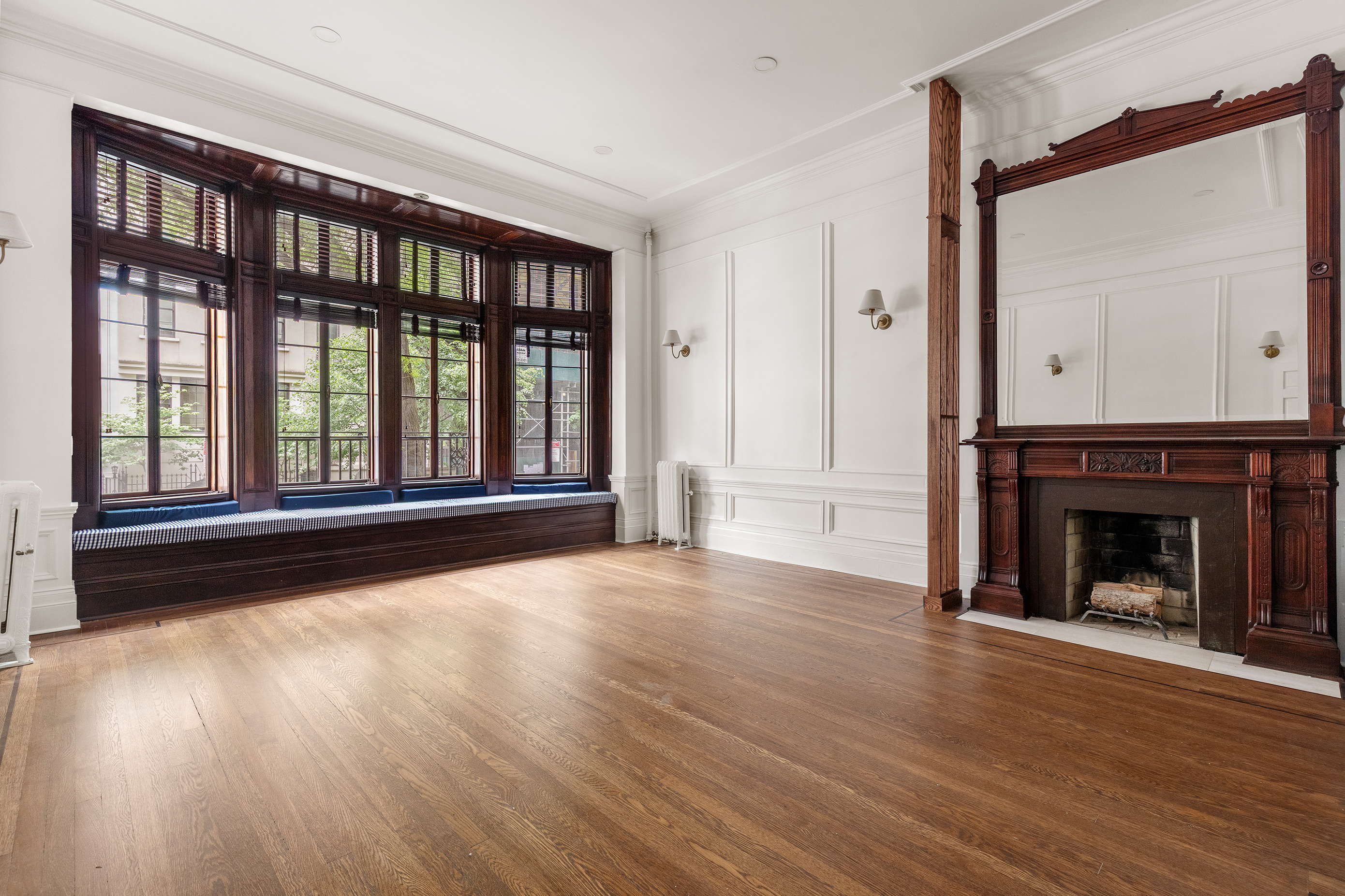 129 East 61st Street, Unit 3 Manhattan, NY 10065 - Photo 1 of 13 a view of an empty room with wooden floor and a window