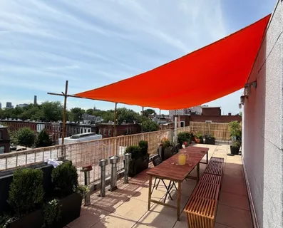a terrace with outdoor seating and city view