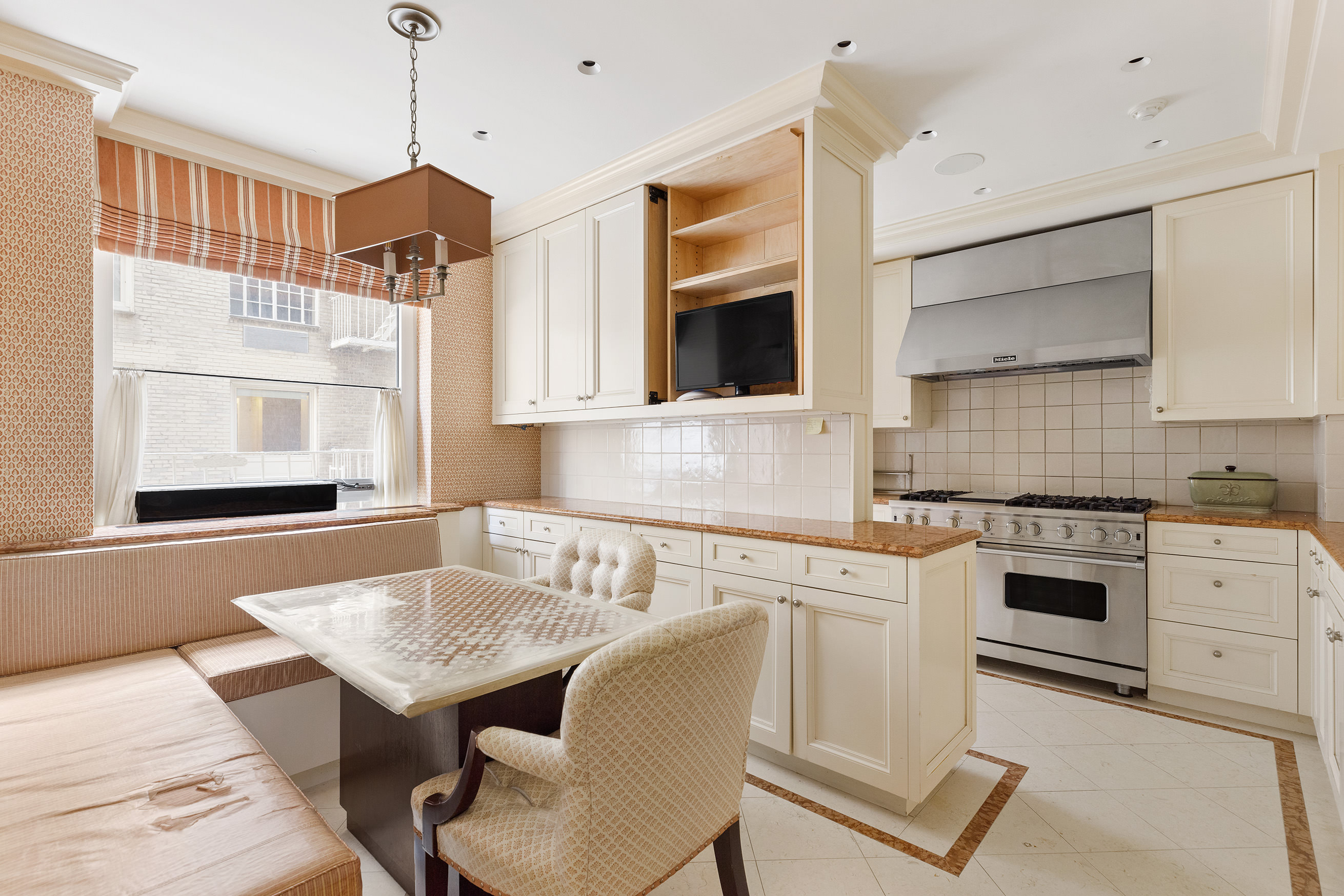15 West 81st Street, Unit 2D Manhattan, NY 10024 - Photo 7 of 31 a kitchen with stainless steel appliances granite countertop a stove top oven a sink a counter space and cabinets