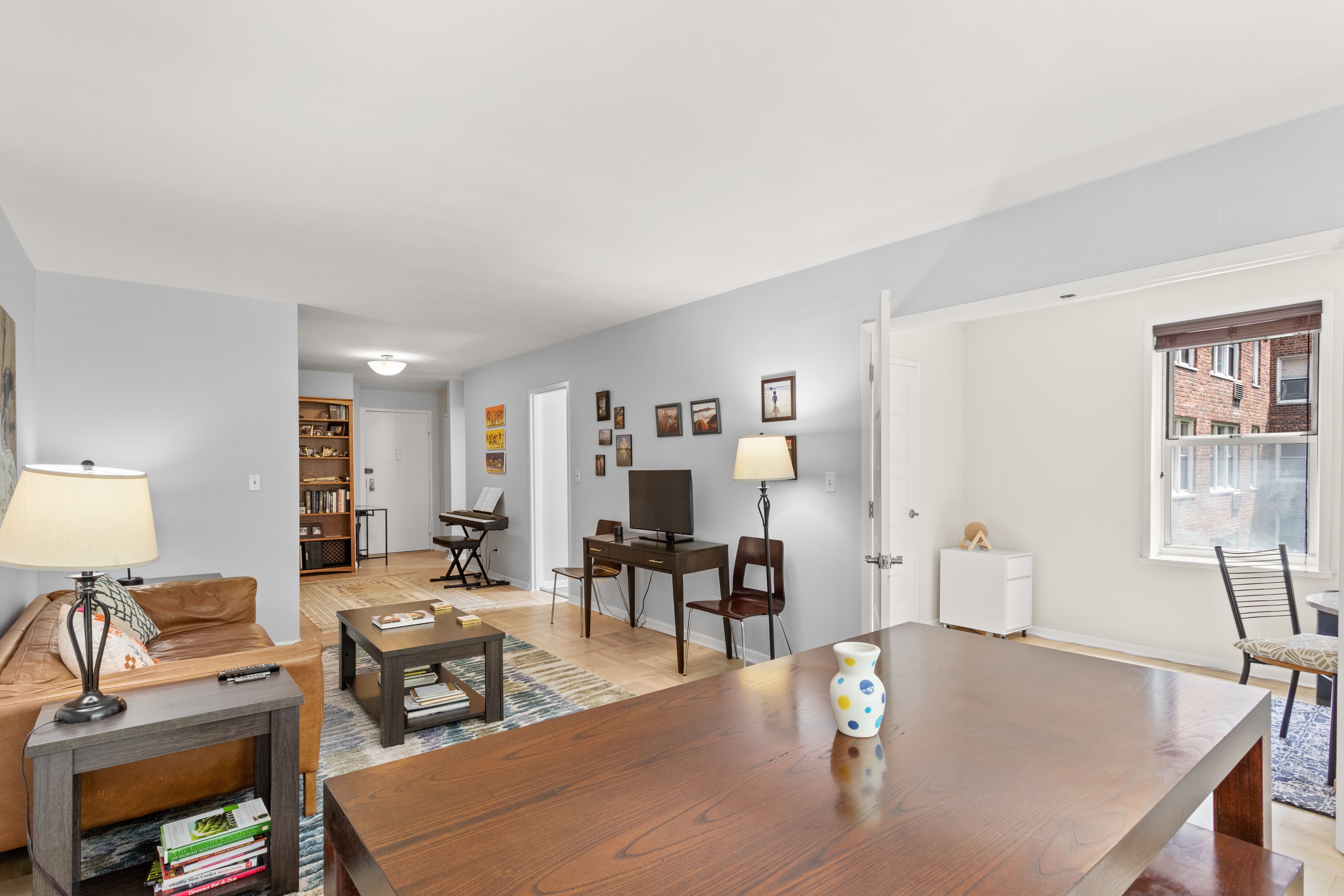66 Overlook Terrace, Unit 4K Manhattan, NY 10040 - Photo 4 of 26 a living room with furniture and wooden floor
