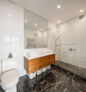 a bathroom with a sink a toilet and a shower