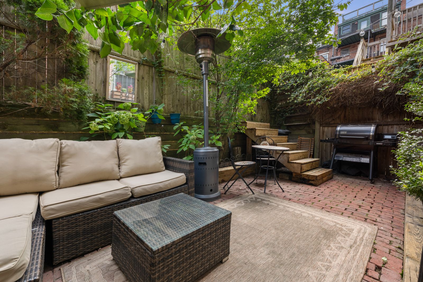 484 Massachusetts Avenue, Unit 1 Boston, MA 02118 - Photo 14 of 20 a view of a patio with couches and a fire pit and wooden fence