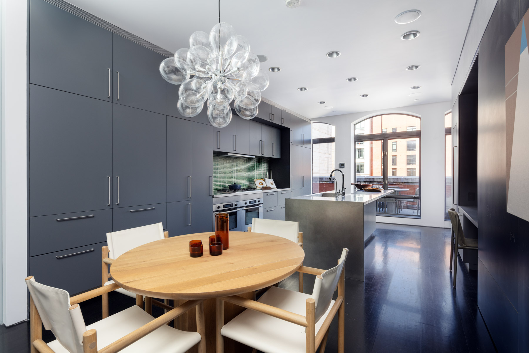 92 Laight Street, Unit PHC Manhattan, NY 10013 - Photo 8 of 16 a view of a dining room with furniture a chandelier and wooden floor