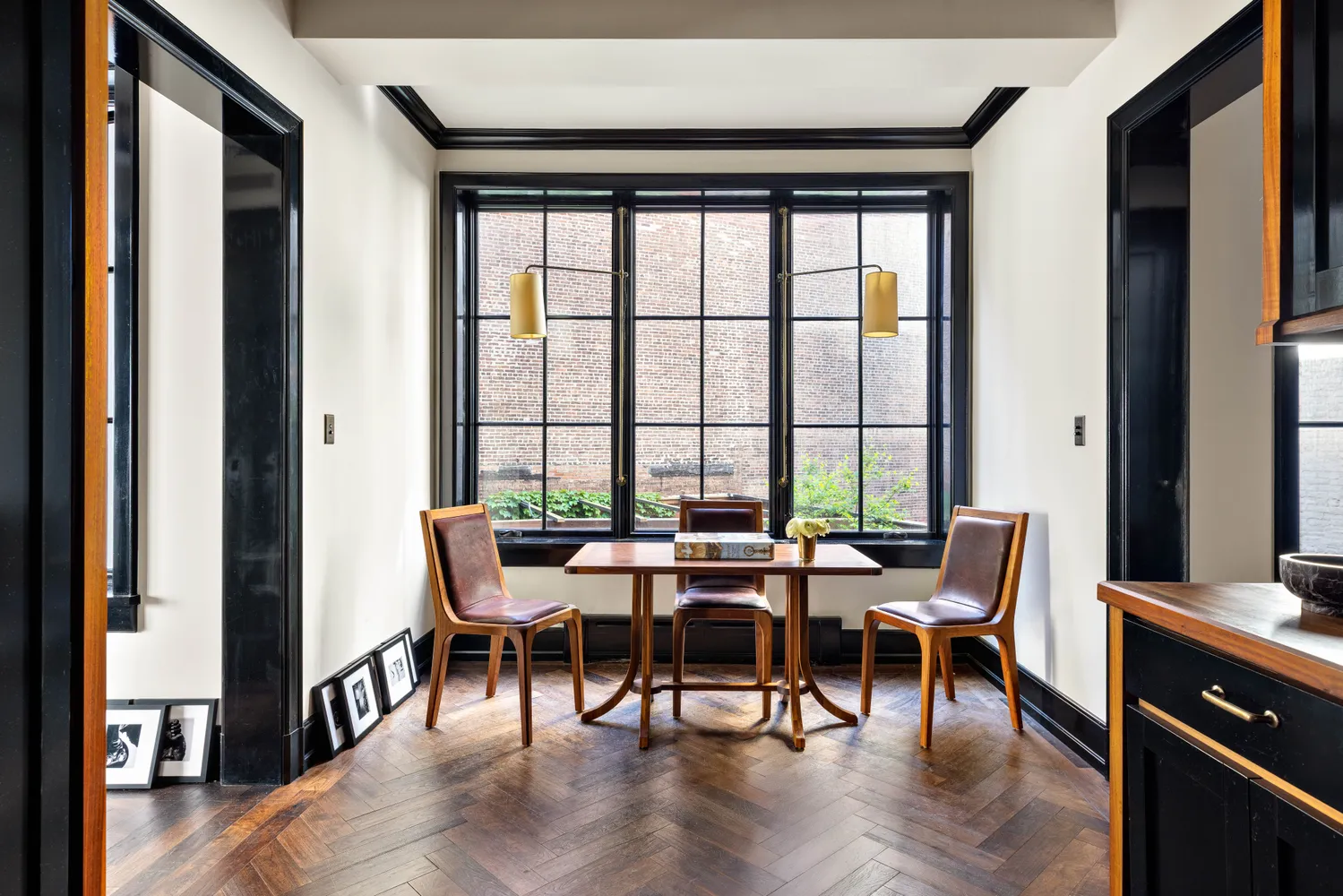 a dining room with furniture window and wooden floor