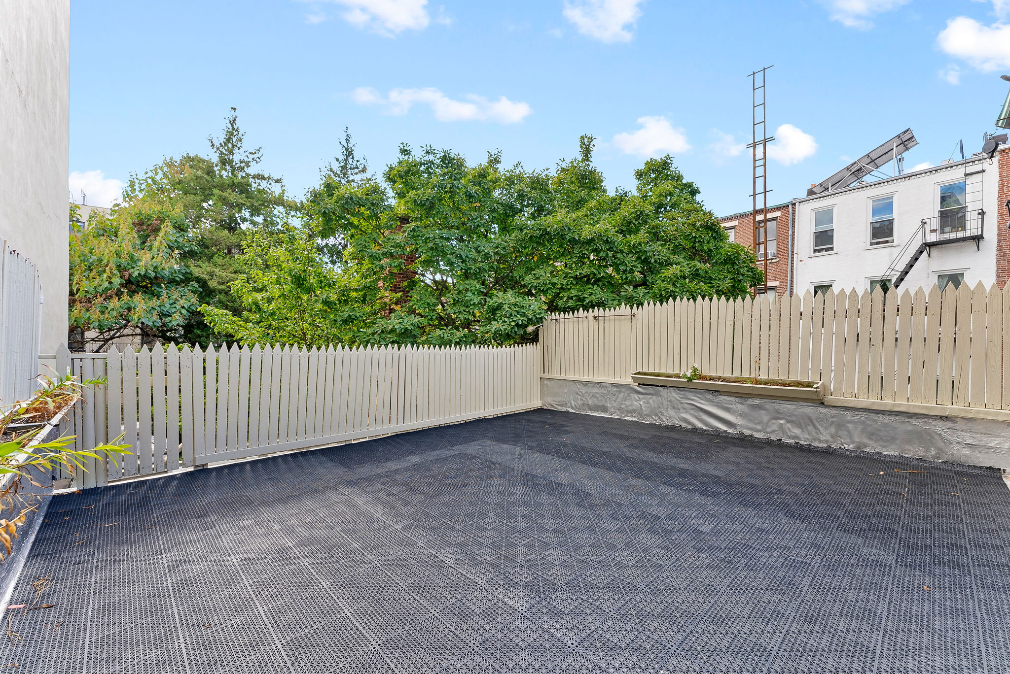 710 Carroll Street Brooklyn, NY 11215 - Photo 8 of 10 a view of a house with a fence