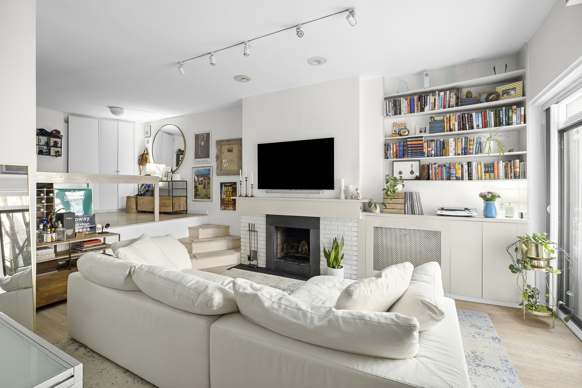 19 West 85th Street, Unit 3B Manhattan, NY 10024 - Photo 3 of 12 a living room with furniture a fireplace and a flat screen tv