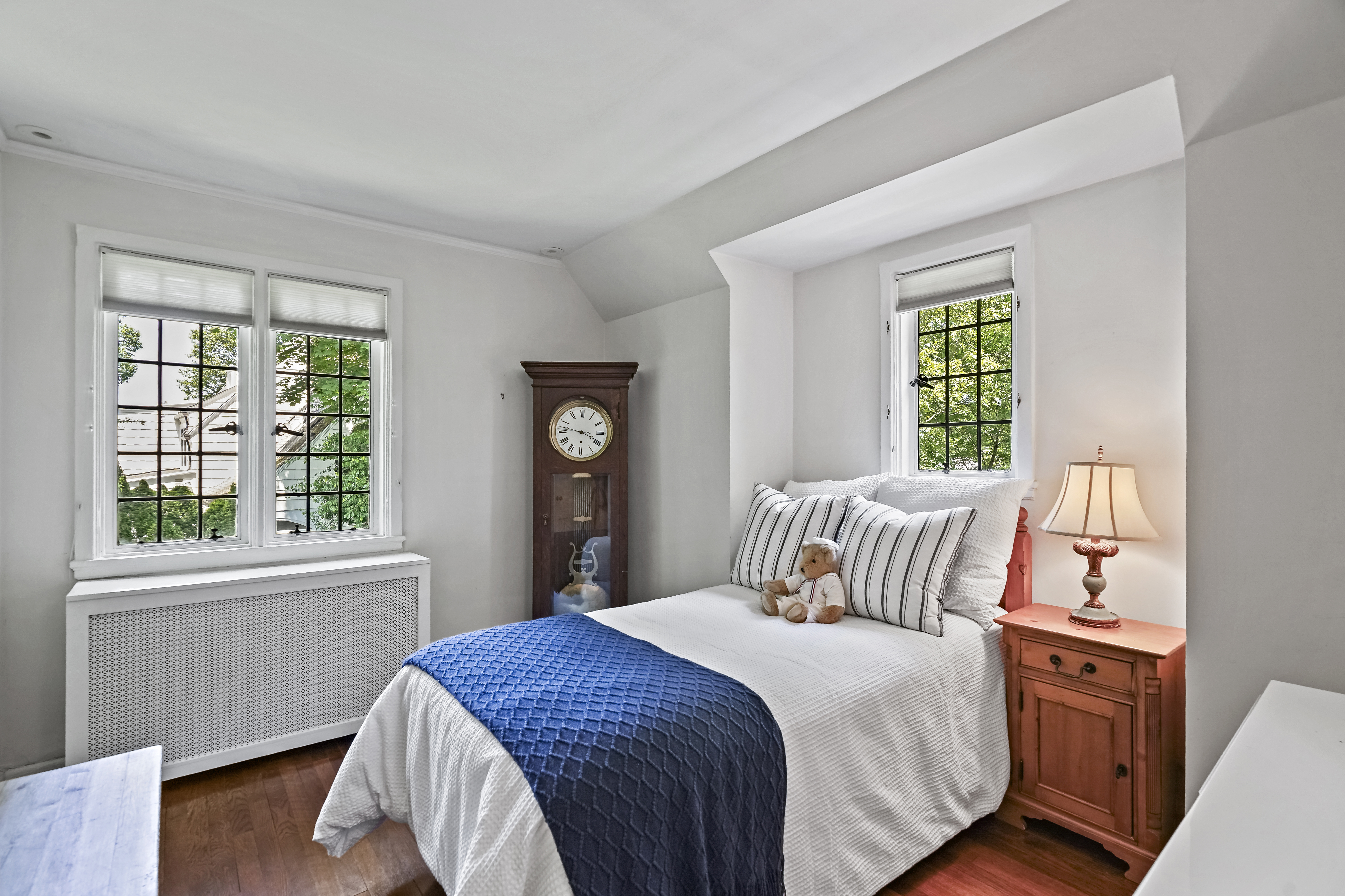 19 Avon Road Larchmont, NY 10538 - Photo 19 of 35 a bedroom with a bed and a window