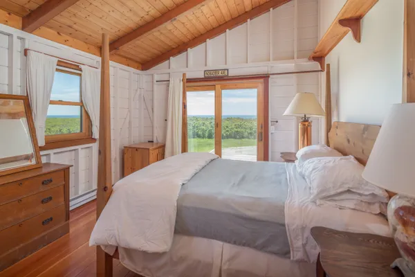 a bed sitting in a bedroom next to a window