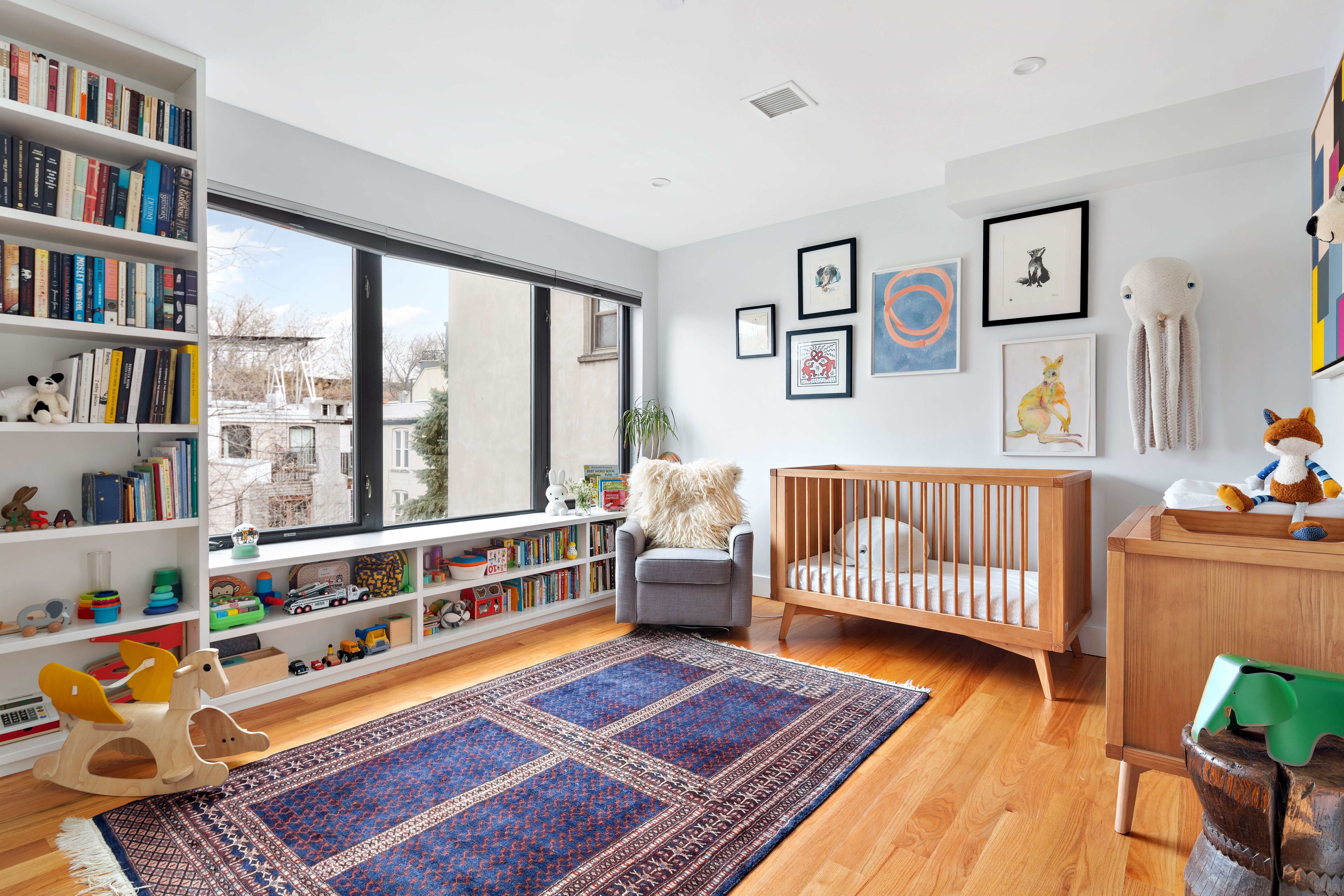 39 Madison Street, Unit 3B Brooklyn, NY 11238 - Photo 5 of 16 a bedroom with furniture and a book shelf