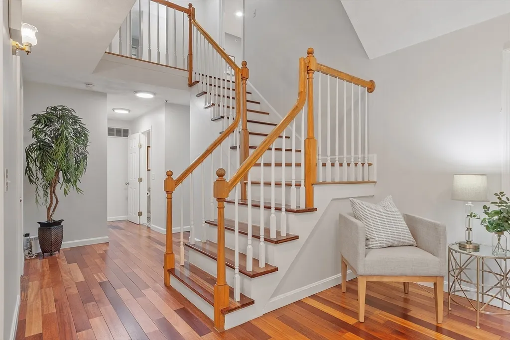 a view of entryway with wooden floor and stairs
