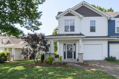 a view of a house with yard and plants