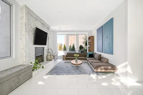 a living room with fireplace furniture and a flat screen tv