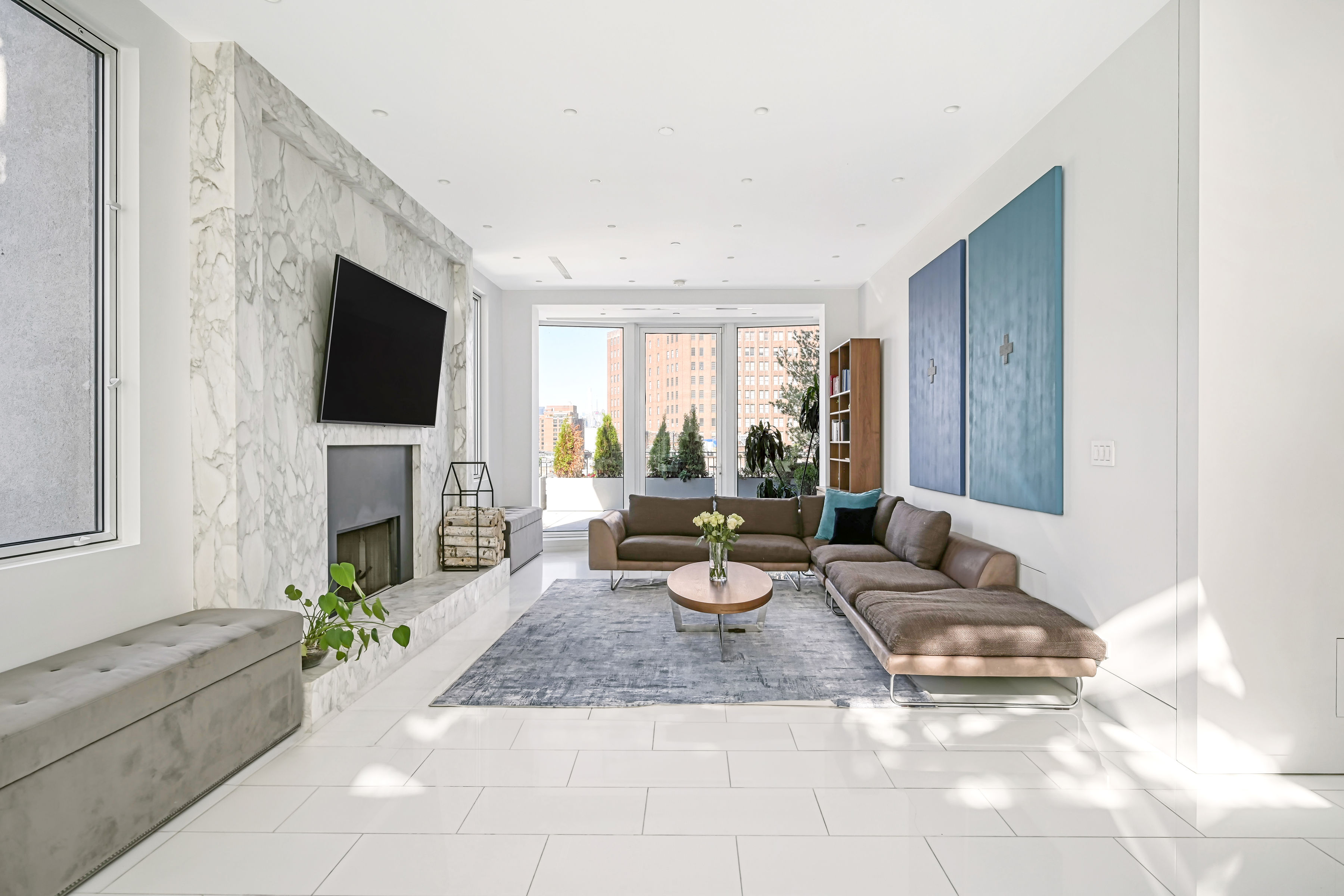 53 Leonard Street, Unit PH Manhattan, NY 10013 - Photo 5 of 24 a living room with fireplace furniture and a flat screen tv