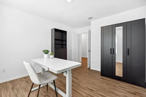 a view of a dining room with furniture and wooden floor