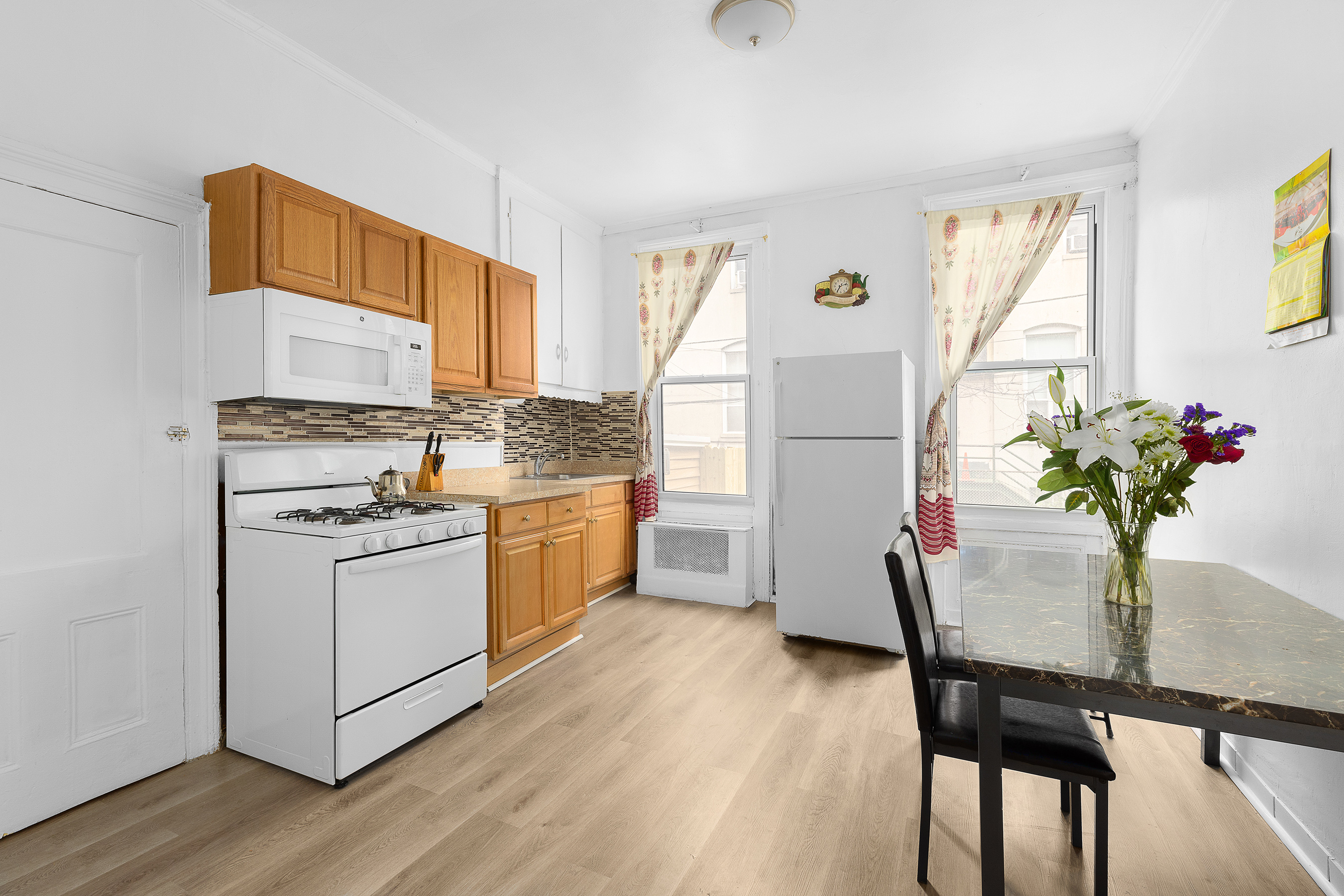 39 Broome Street Brooklyn, NY 11222 - Photo 4 of 16 a kitchen with appliances cabinets and wooden floor