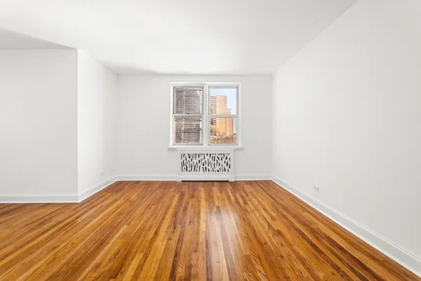 a view of a room with wooden floor and a sink
