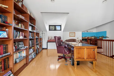 a view of a livingroom with furniture and bookshelf
