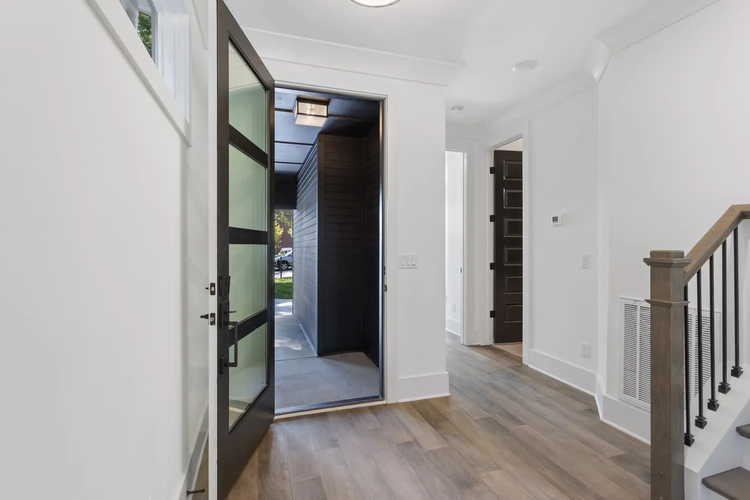 a kitchen with stainless steel appliances granite countertop a stove top oven a refrigerator and white cabinets