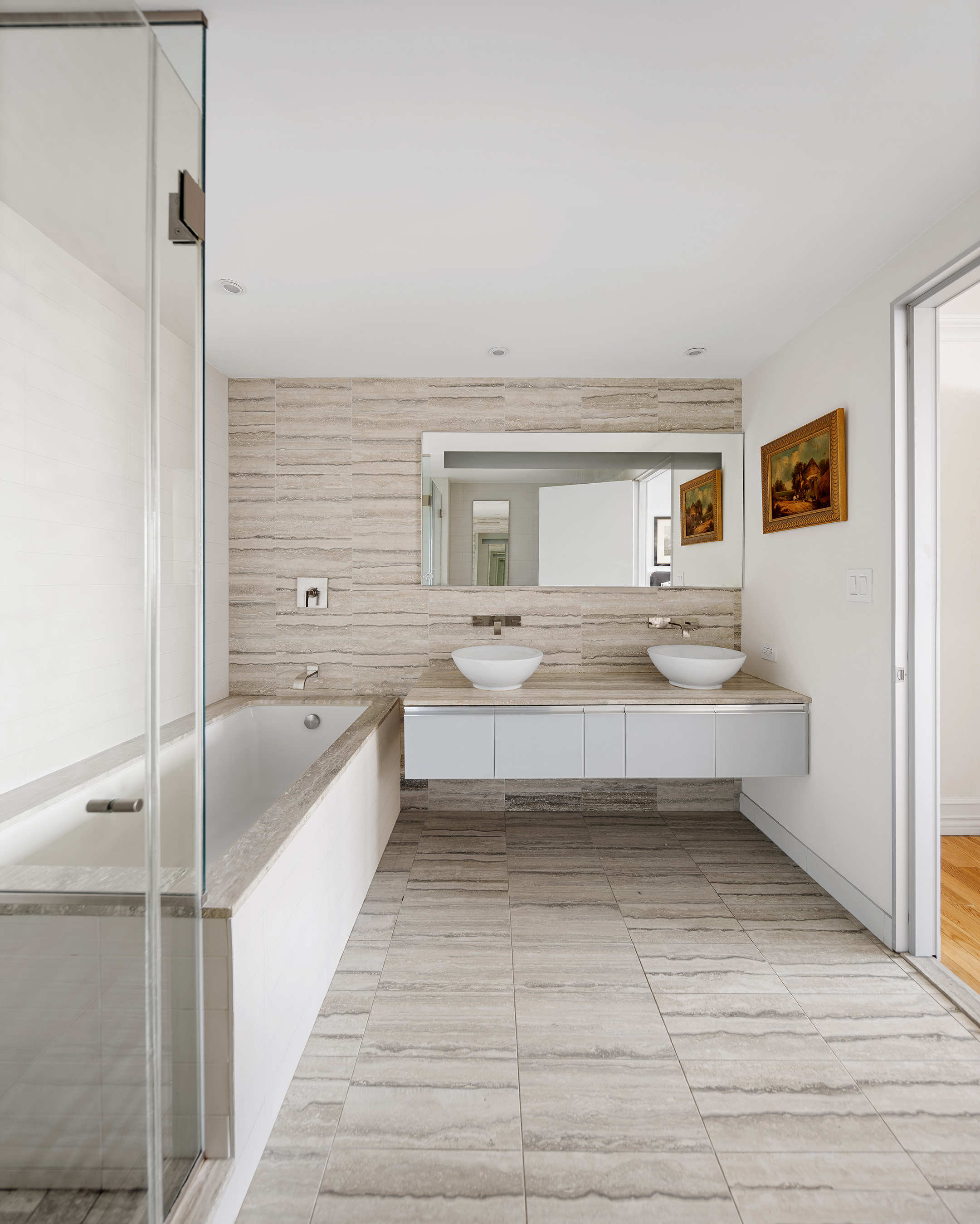 322 West 57th Street, Unit 33U Manhattan, NY 10019 - Photo 11 of 18 a bathroom with a tub sink and mirror
