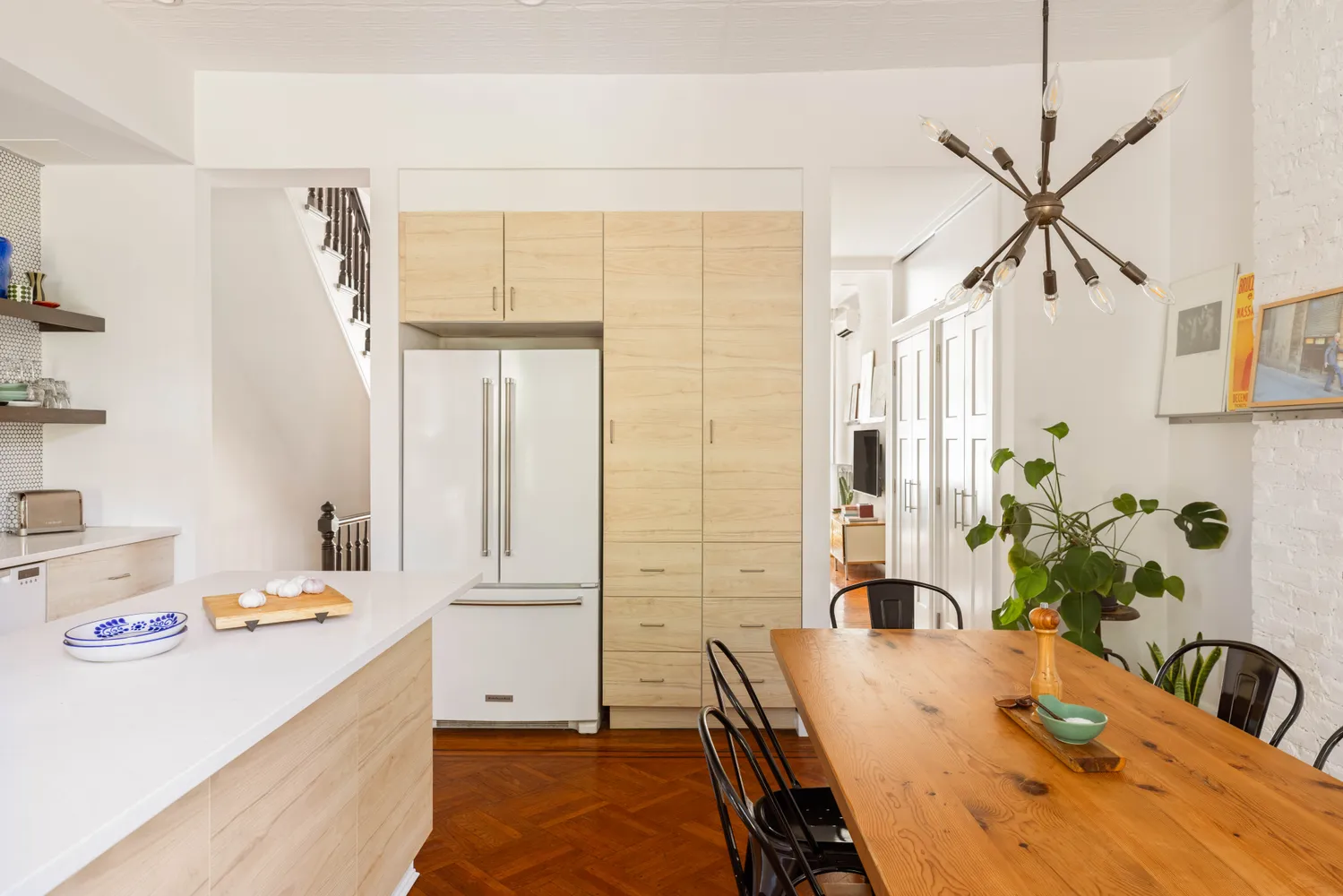 a dining room with a table chairs and entryway