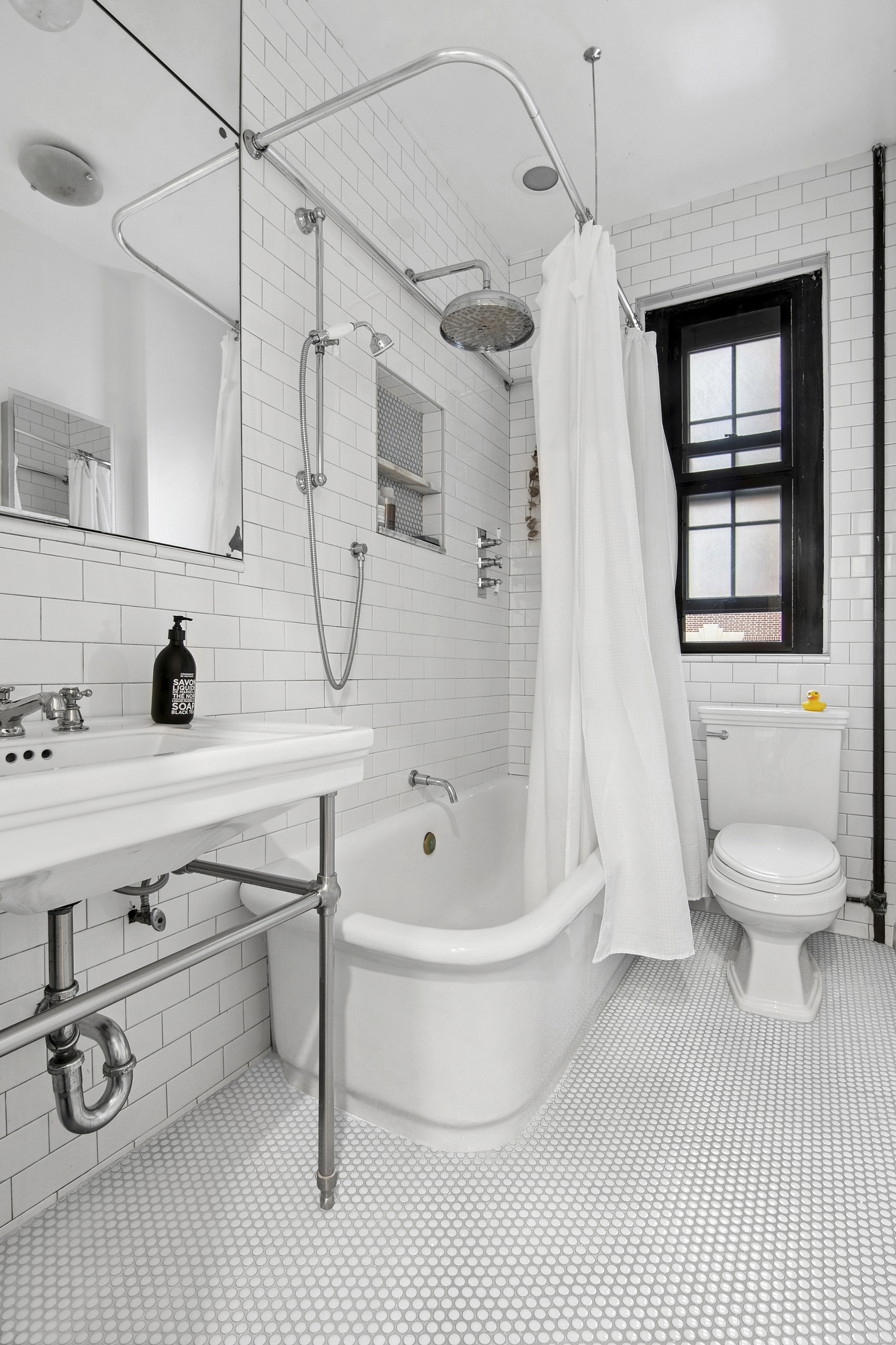 205 Hicks Street, Unit 2B Brooklyn, NY 11201 - Photo 7 of 8 a bathroom with a toilet sink a mirror and shower