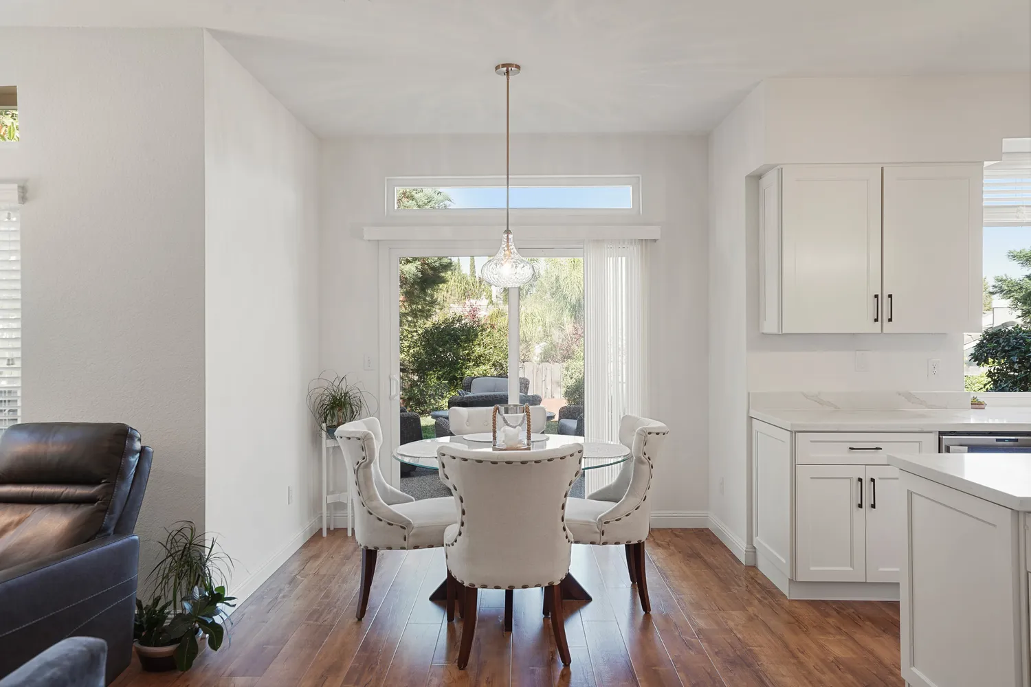 a dining room with furniture window and wooden floor