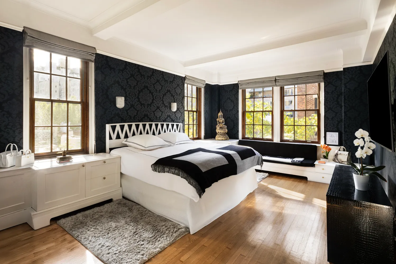 a bedroom with a bed and a large window