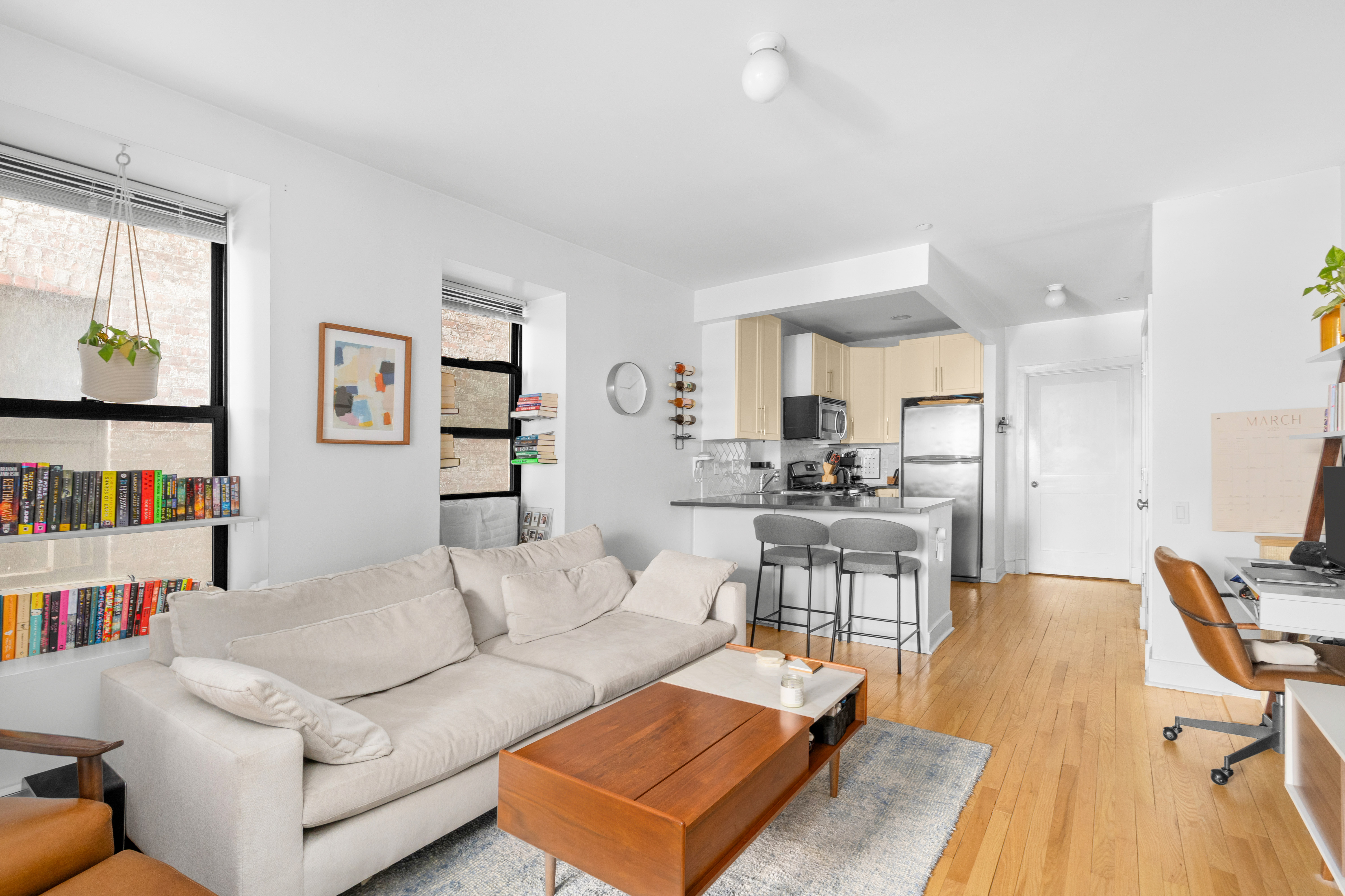 a living room with furniture and a book shelf