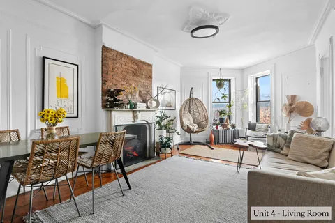 a living room with furniture a rug and a large window