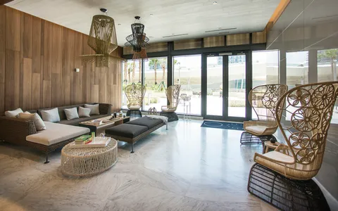 a living room with furniture and a floor to ceiling window