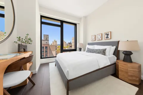 a bed room with a bed and a chair