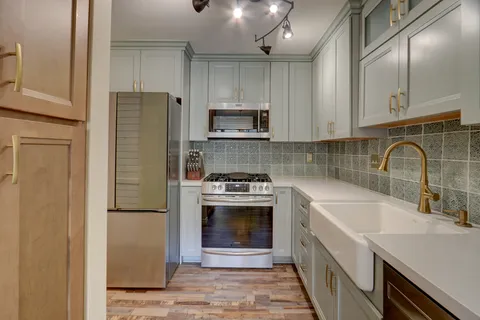 a kitchen with a sink cabinets and stainless steel appliances