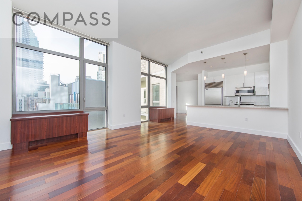 42-51 Hunter Street, Unit 3D Queens, NY 11101 - Photo 4 of 14 a view of an empty room with wooden floor and a window