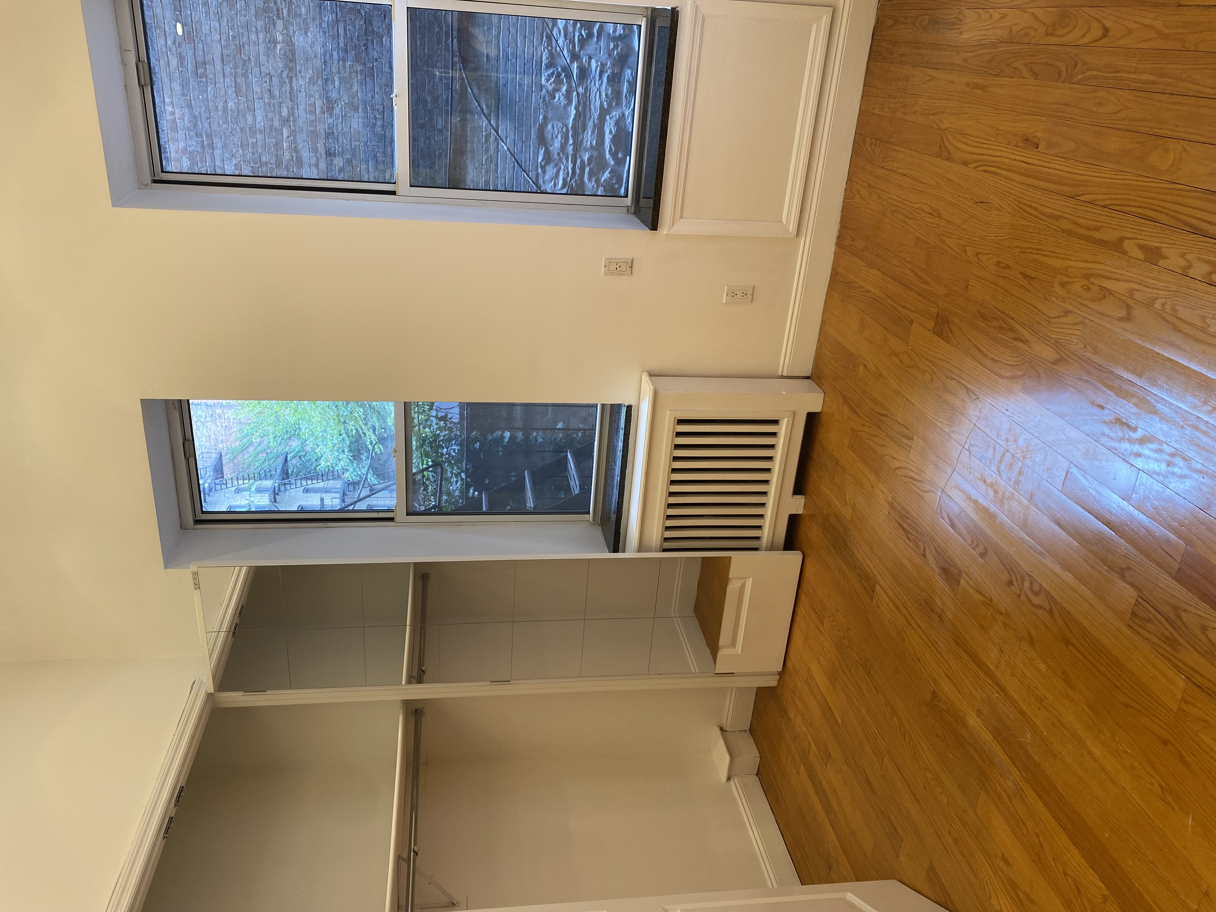 1736 2nd Avenue, Unit DB Manhattan, NY 10128 - Photo 5 of 7 an empty room with wooden floor and windows