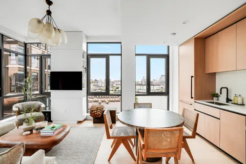 a living room with furniture a flat screen tv and a large window