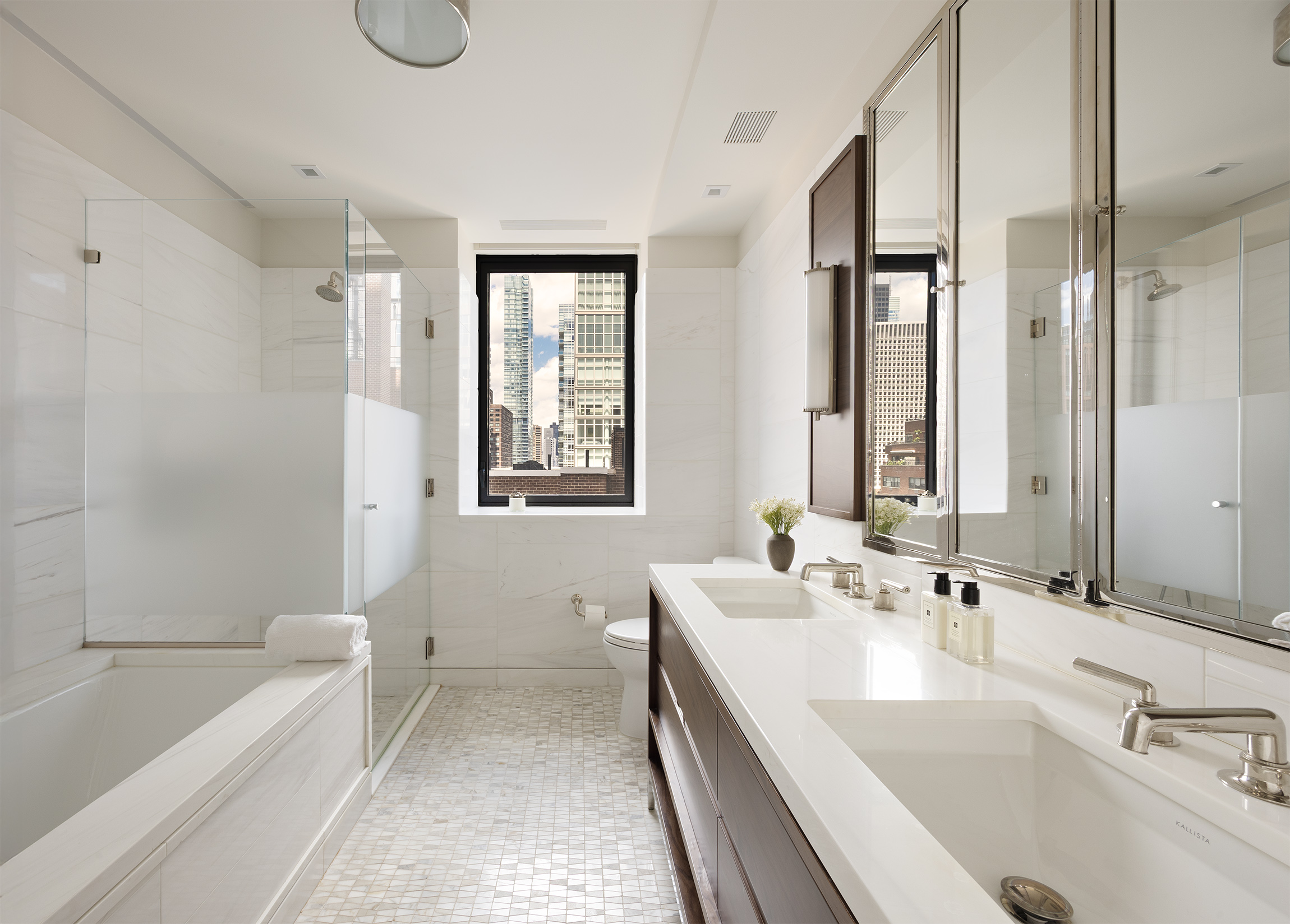 301 East 50th Street, Unit 16B Manhattan, NY 10022 - Photo 6 of 15 a bathroom with a tub sink and mirror