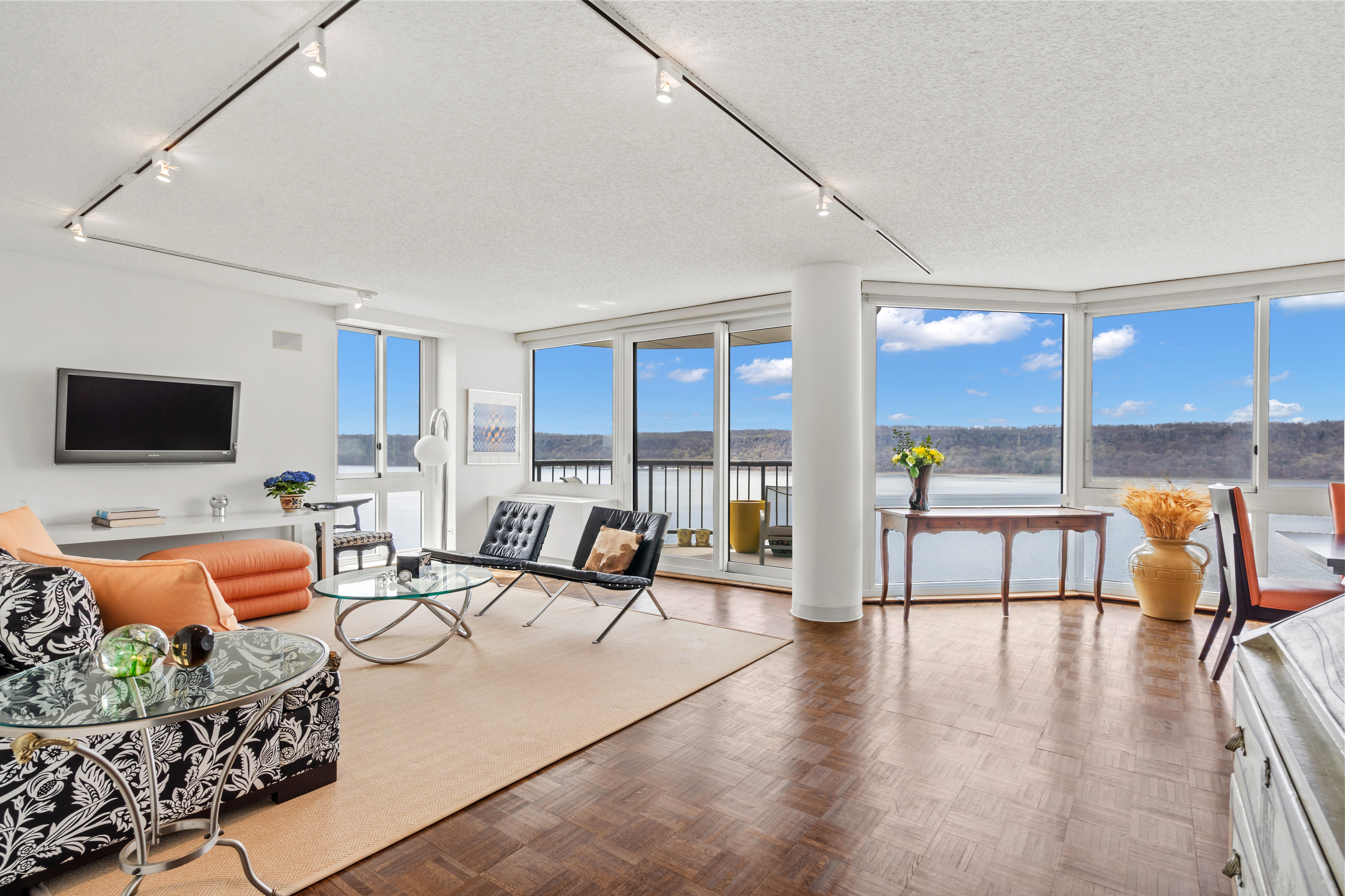 a living room with furniture and floor to ceiling window