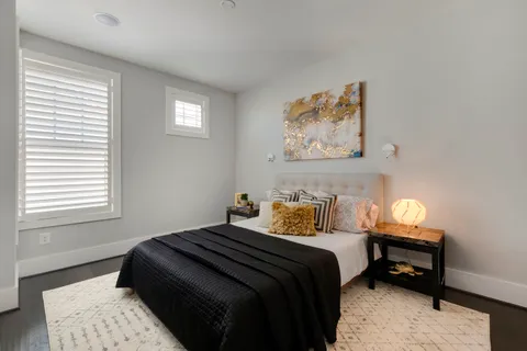 a bedroom with a bed and a window