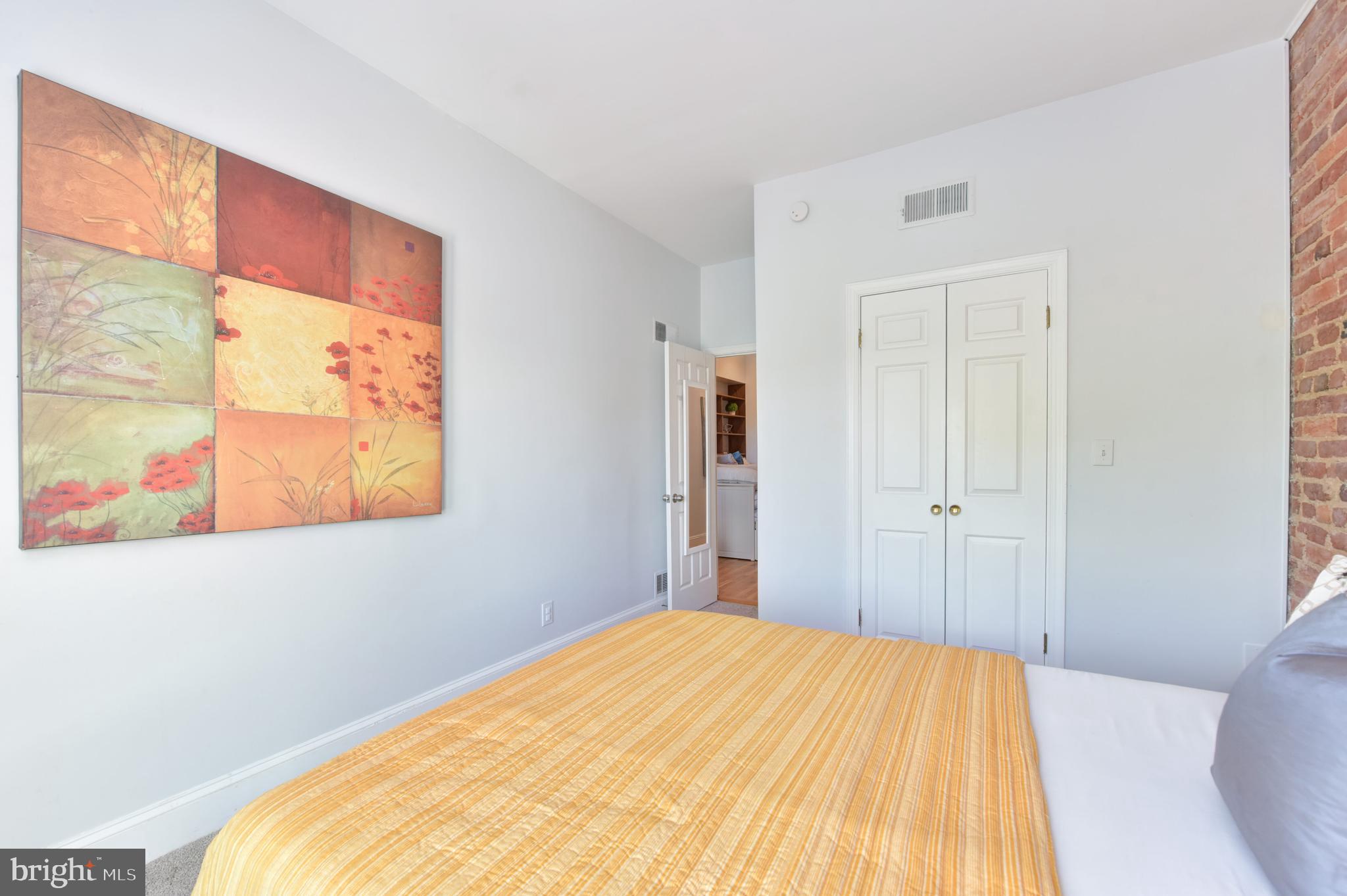 629 5th Street Northeast Washington, DC 20002 - Photo 21 of 31 a bed room with a bed and a painting on the wall