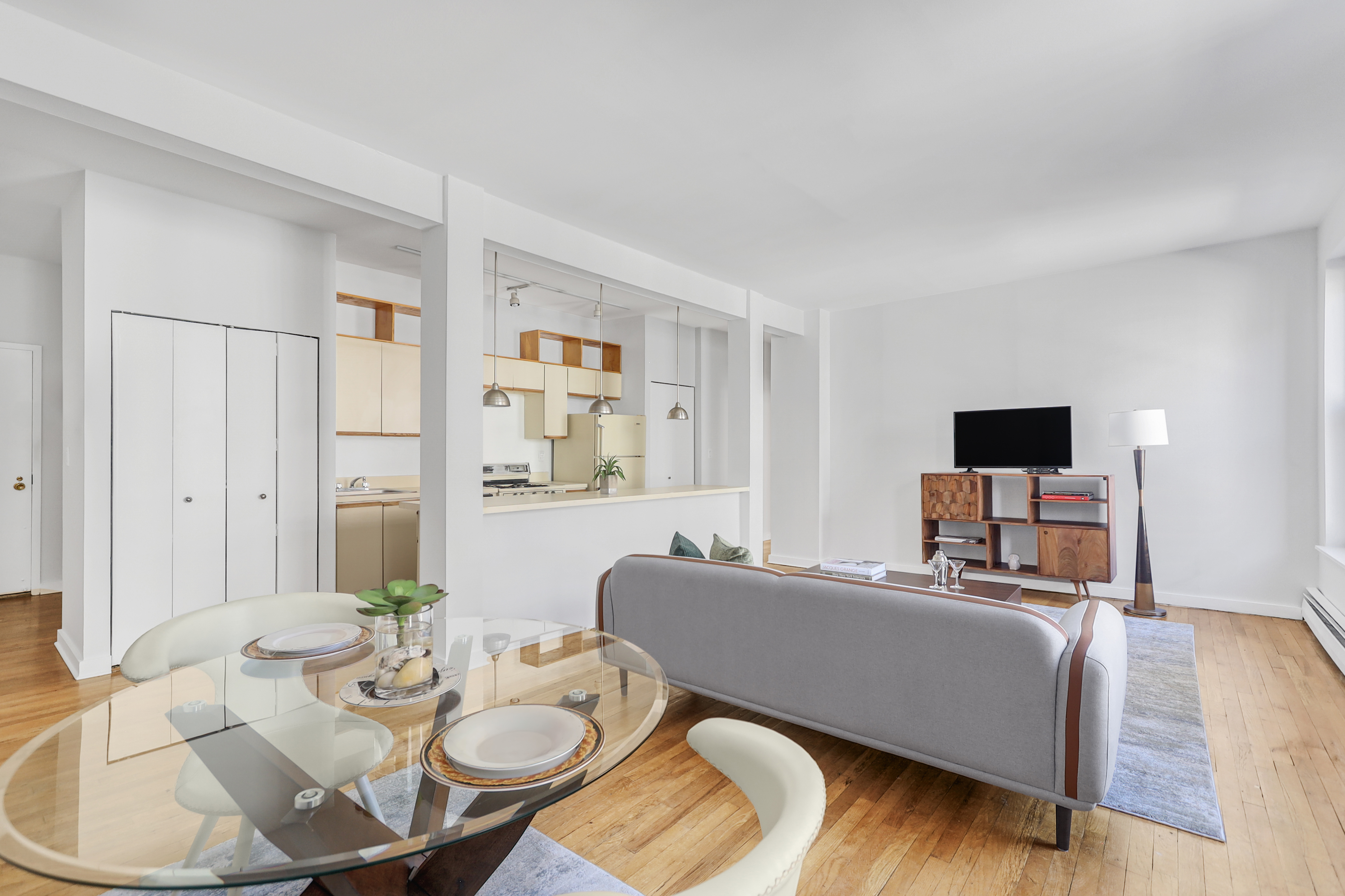 314 West 94th Street, Unit 5D Manhattan, NY 10025 - Photo 1 of 13 a living room with furniture and a flat screen tv