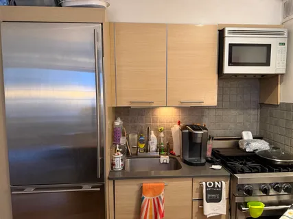 a kitchen with a refrigerator and a stove