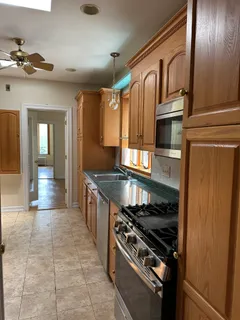 a kitchen with stainless steel appliances granite countertop a stove and a sink