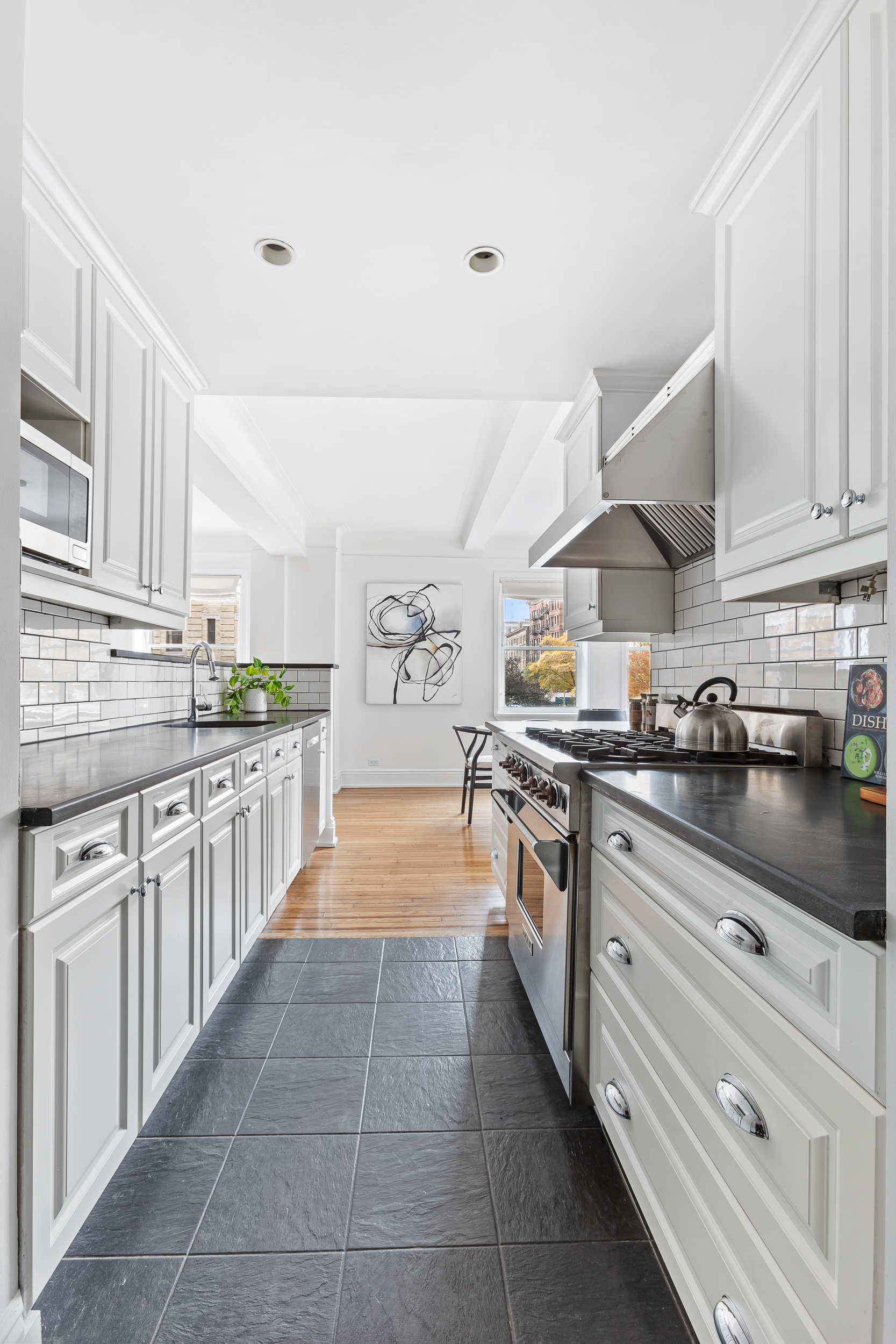 49 East 96th Street, Unit 4D Manhattan, NY 10128 - Photo 5 of 18 a large kitchen with stainless steel appliances lots of counter space cabinets and a sink