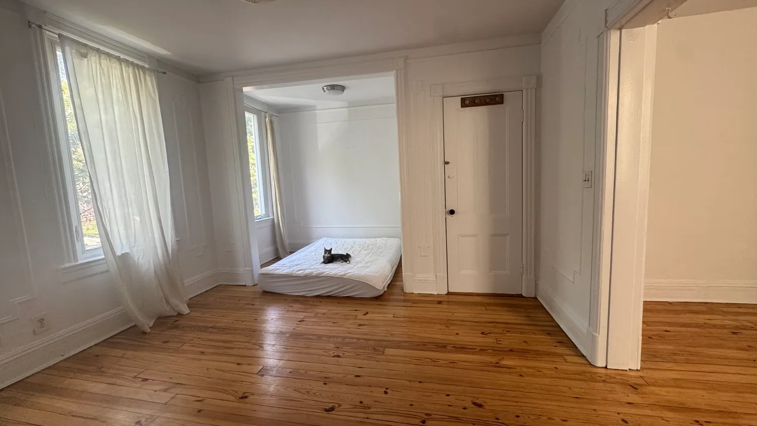 a view of room with window and wooden floor