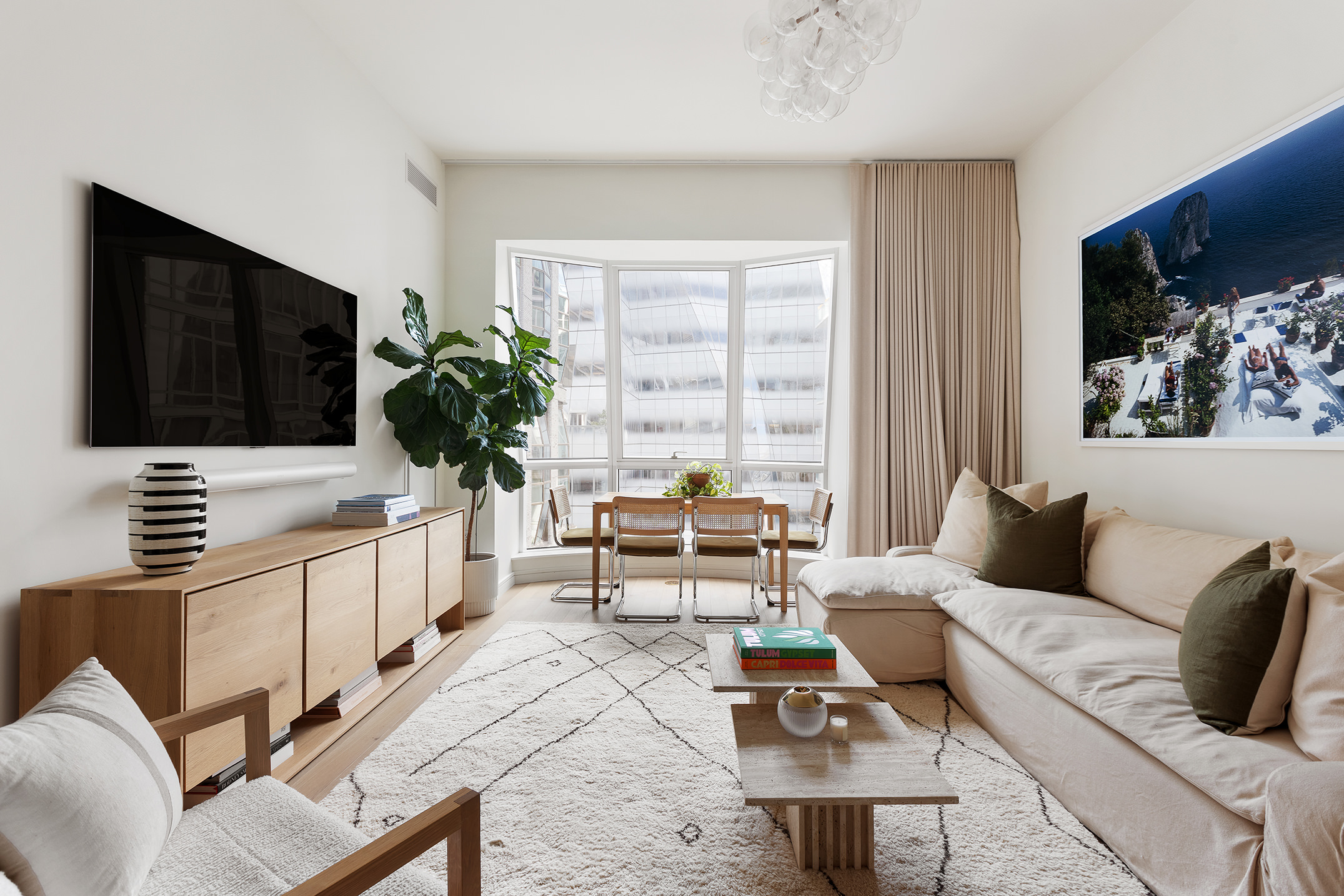515 West 18th Street, Unit 701 Manhattan, NY 10011 - Photo 1 of 15 a living room with furniture and a flat screen tv
