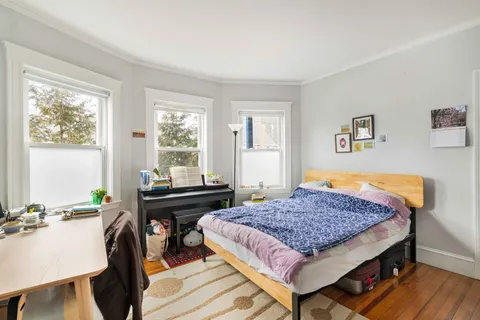 a bedroom with a bed and a table in it