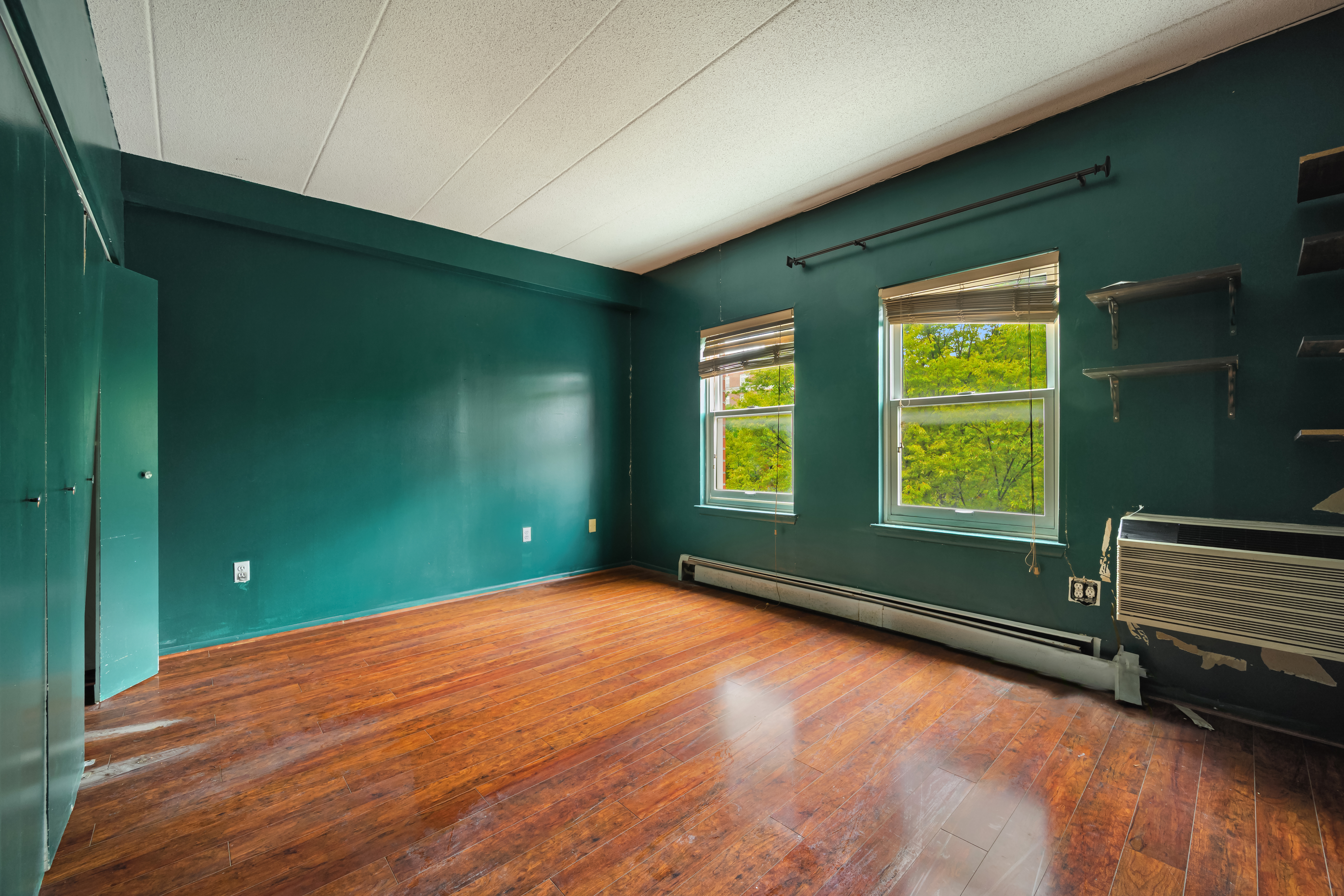 2560 Frederick Douglass Boulevard, Unit D Manhattan, NY 10030 - Photo 6 of 12 a view of an empty room with window and wooden floor