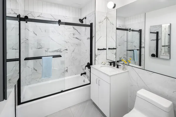 a bathroom with a sink toilet and shower