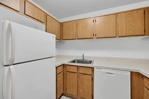 a kitchen with stainless steel appliances white cabinets and a refrigerator