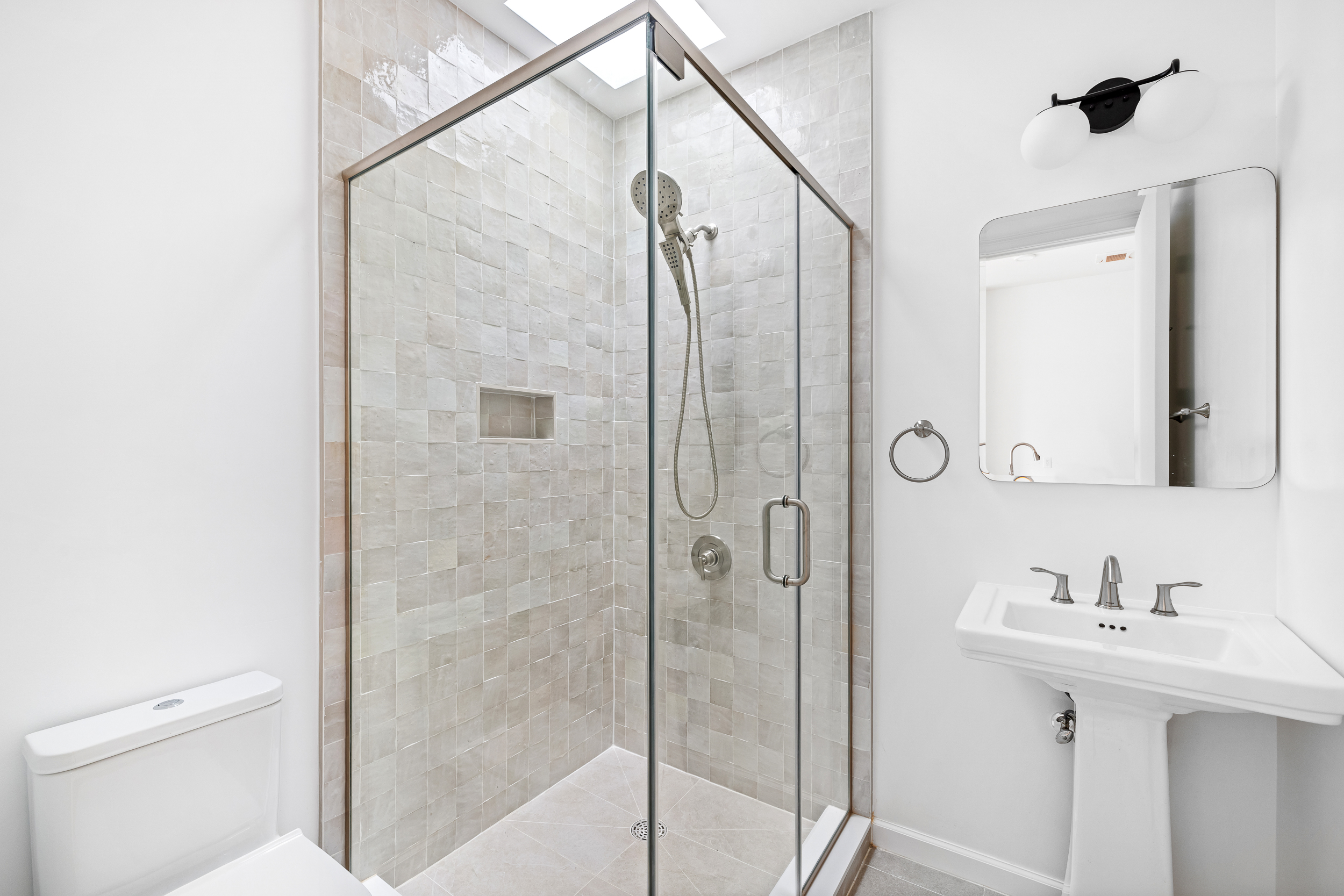 317 Court Street, Unit 3 Brooklyn, NY 11231 - Photo 9 of 15 a bathroom with a shower sink and mirror
